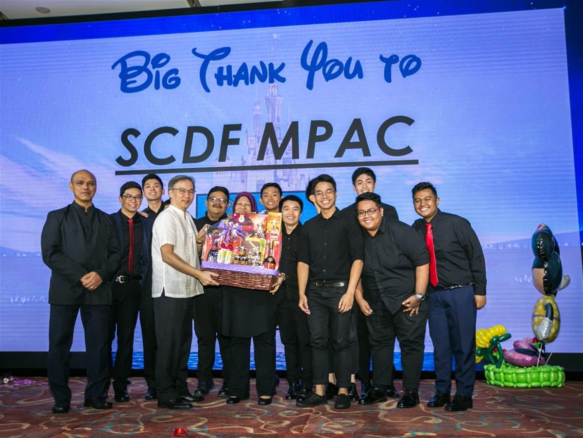 MPAC receiving a token of appreciation from Mr Pang Kin Keong, Permanent Secretary, Ministry of Home Affairs (MHA) after performing at an MHA lunch party