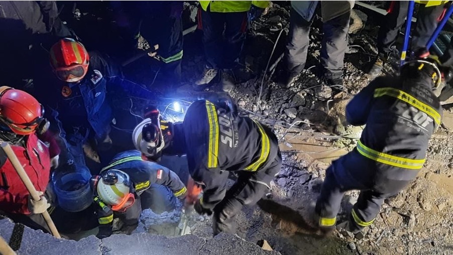 The SCDF team, a Spanish team and a local team using cutting and breaking equipment at the site