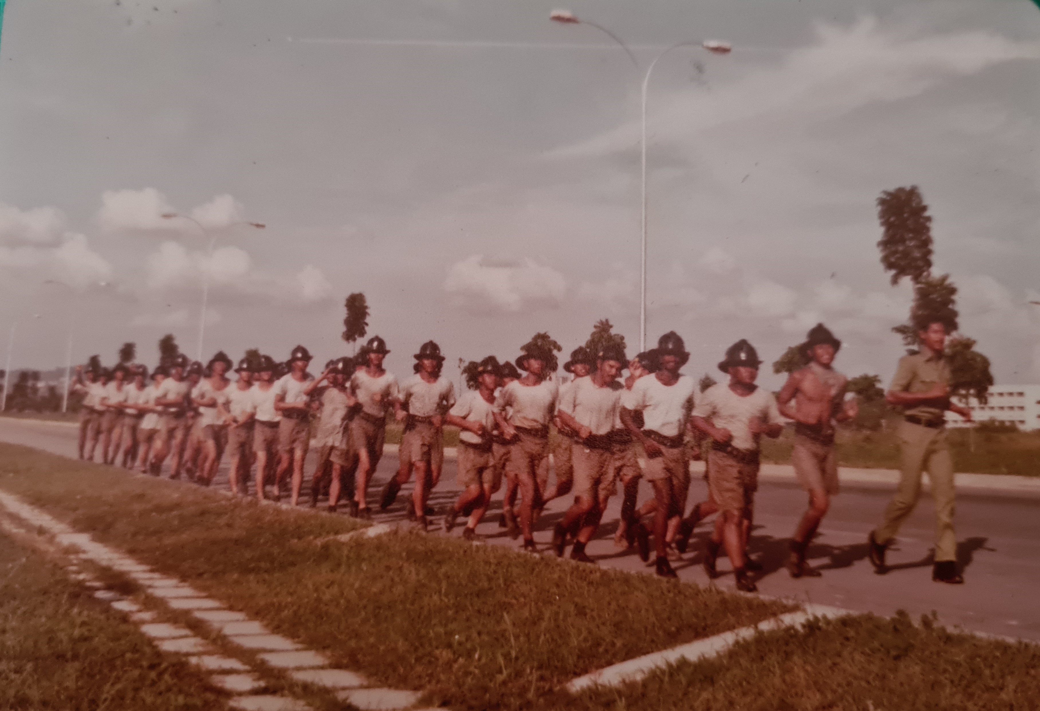 Encik Agayle jogging with the recruits back to Jurong Fire Station after a drill at Chinese Garden (April 1980).