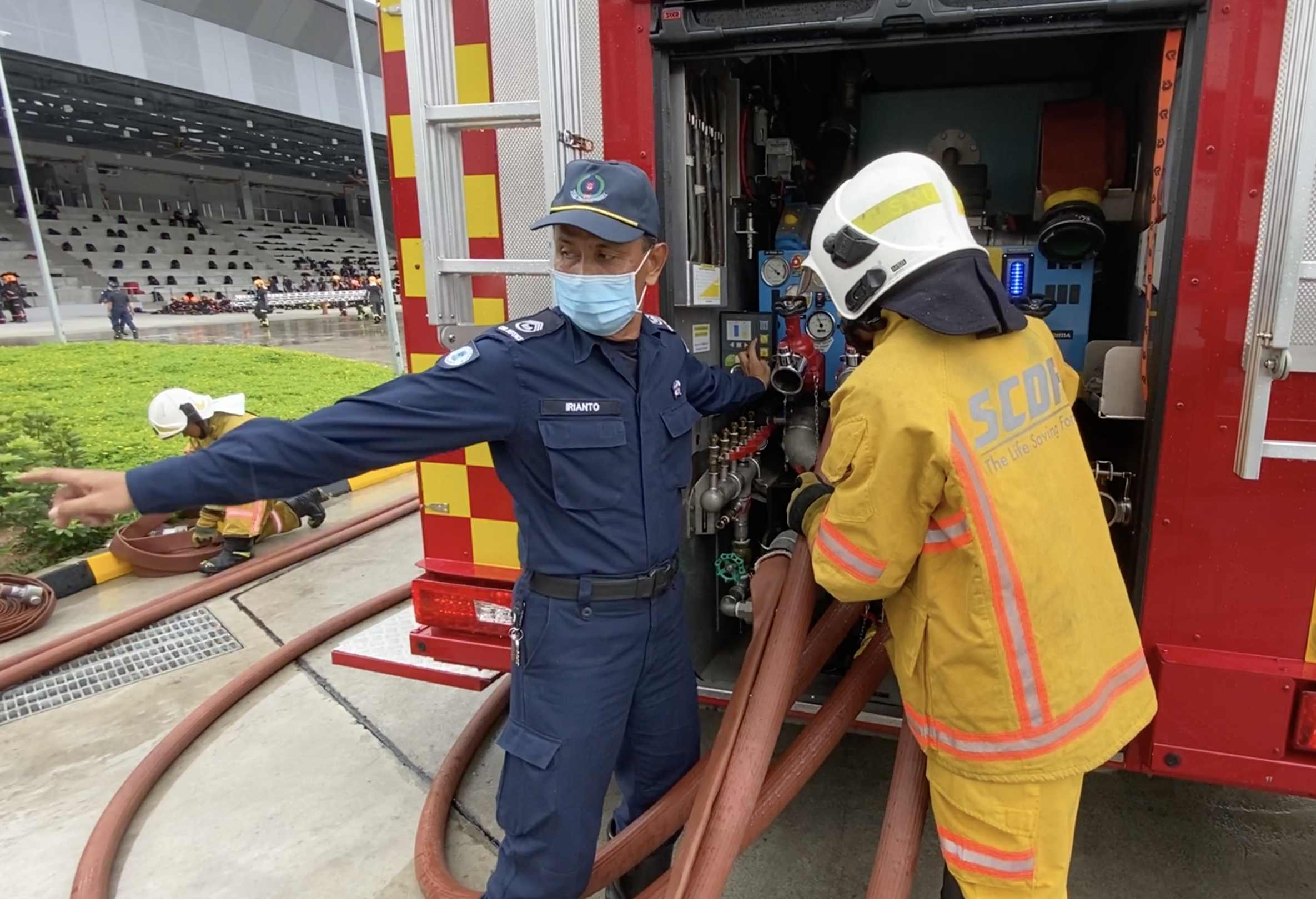 SWO1 Irianto guiding a trainee in operating the pump of a pump ladder