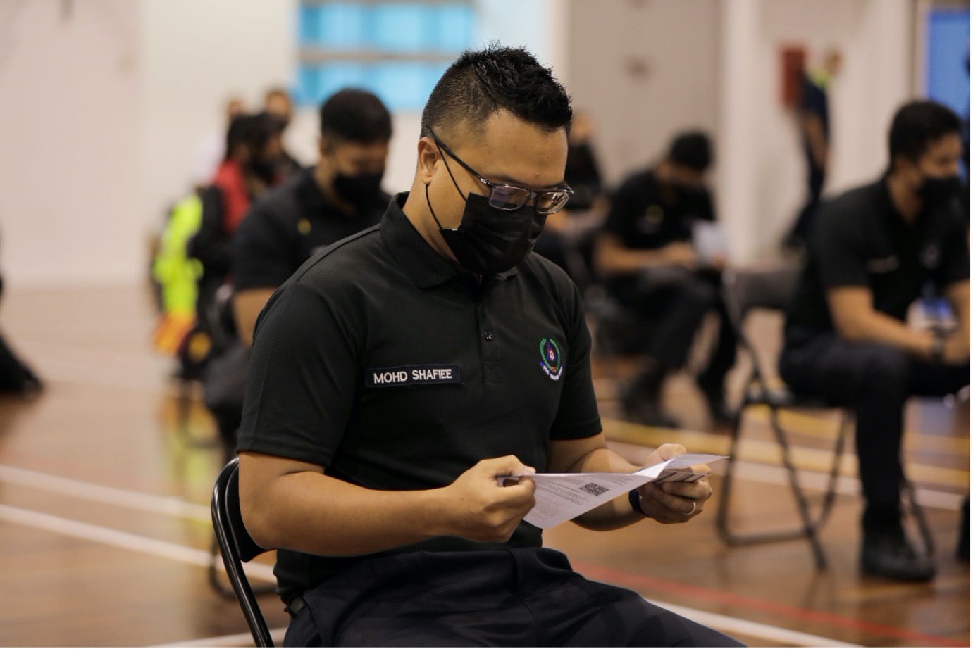 WO1 Mohamed Shafiee bin Jamin waiting in line with other SCDF officers for his turn to receive the vaccination.