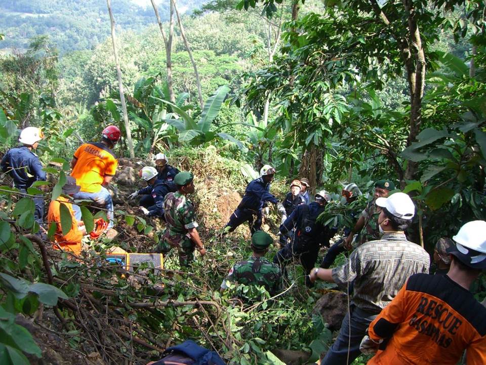 DART rescuers working with the local authorities and rescuers in search of a missing person on a mountain at Yogyakarta, Indonesia, in 2006.
